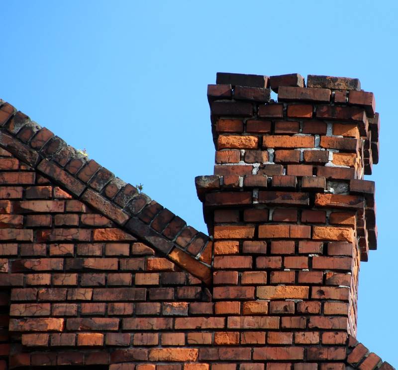 Signs Your Clarksburg Home Needs a Chimney Inspection Blog Article - Damaged chimney on an Clarksburg home showing cracks and missing mortar
